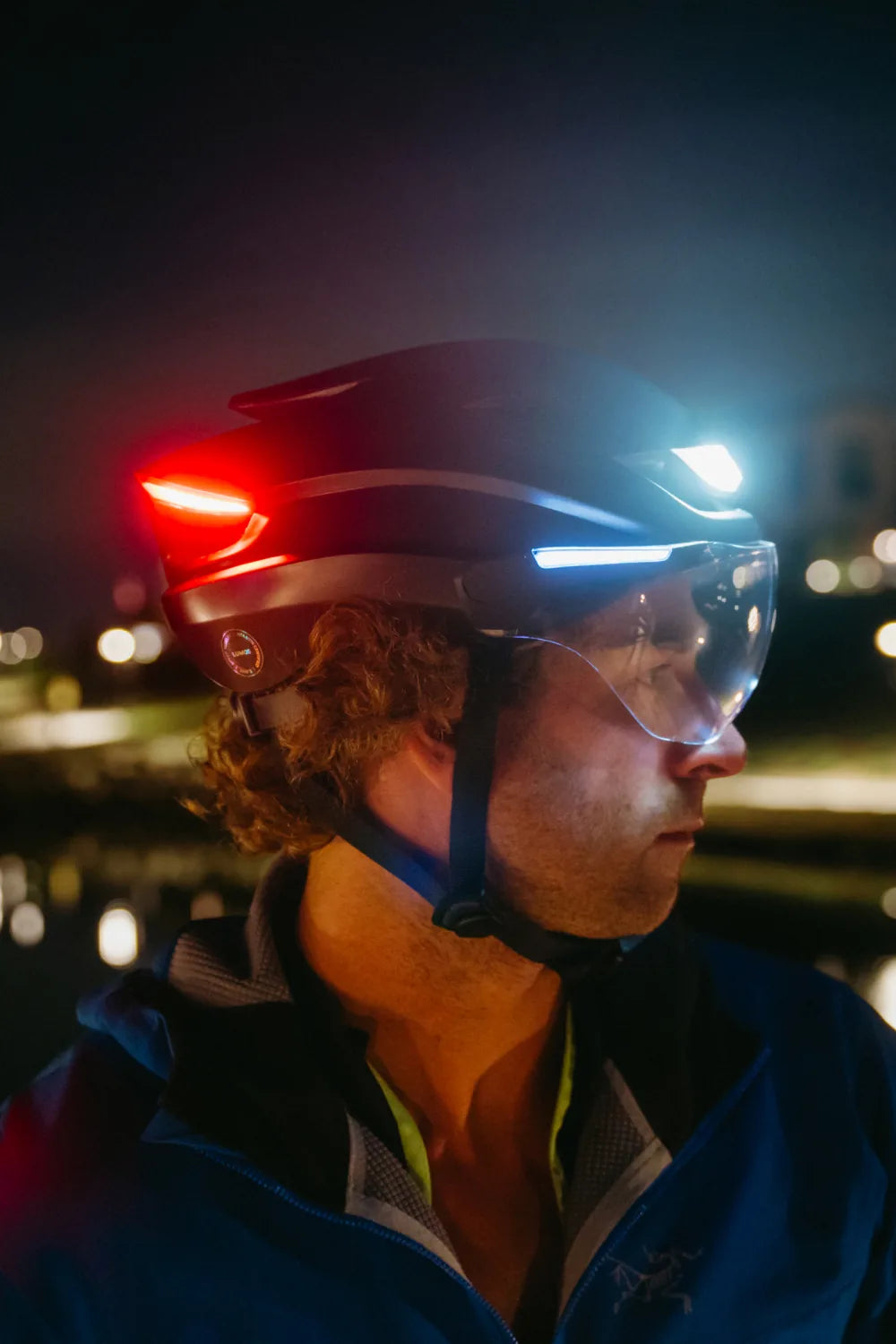 Rider at night wearing Lumos Ultra E-Bike in Onyx Black with the lights on